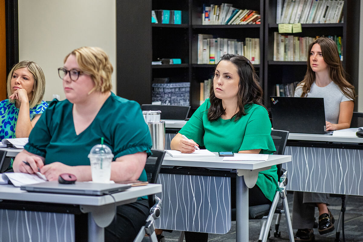 OKPCA employees taking notes during a meeting